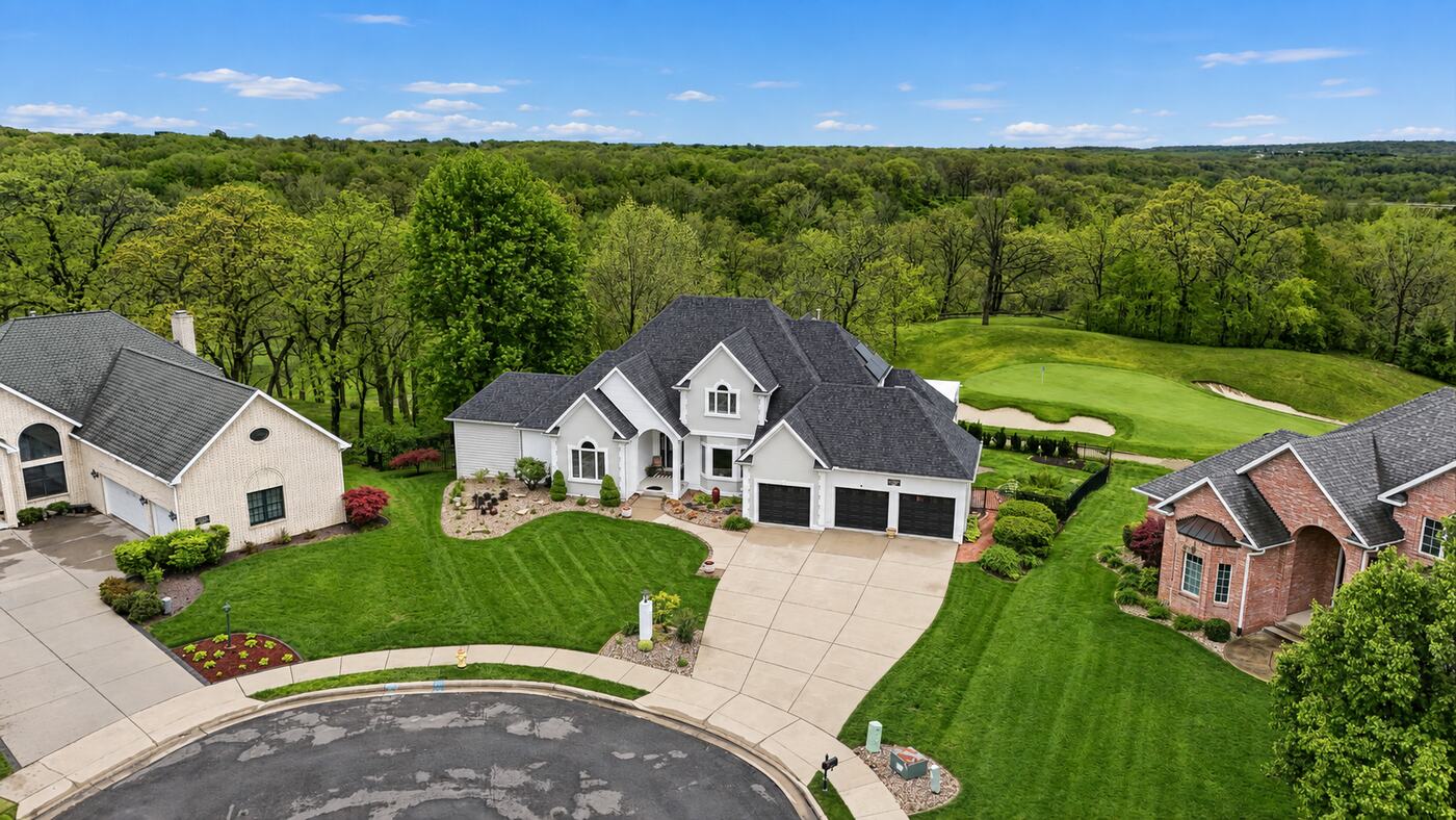 Aerial view of a two-storey home backing onto a golf course